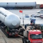 Large horizontal reactor vessel on a heavy transport trailer at the manufacturer’s yard.